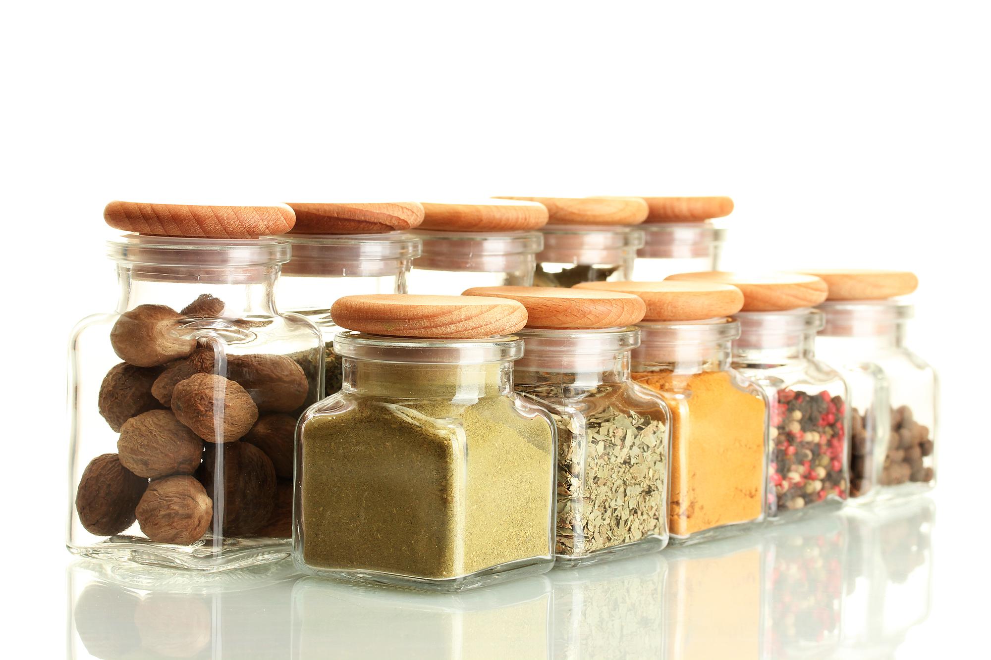 Colorful spice jars on kitchen shelf